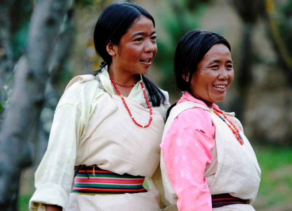 Zwei freundlich lächelnde bhutanische Frauen in traditionellen Kleider n